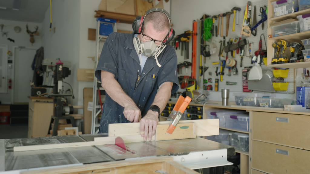 Artist Shawn Smith cuts work in his artist workshop